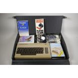 A Commodore 64 with accessories and carry case, 24½" x 16"