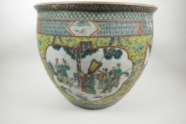 A large Chinese ceramic fish bowl, the interior decorated in bright enamels with carp, the outer