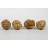 A set of four Japanese tagua nut figural carvings, 1½" diameter