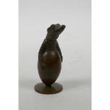 A Japanese Jizai style bronzed metal figure of a crocodile hatchling breaking through its egg,