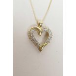 A 14ct yellow gold and diamond set, heart shaped pendant necklace, 1" drop