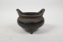 A Chinese bronze censer with two phoenix eye handles and tripod feet, impressed 4 character mark