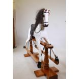 A large dappled painted pine rocking horse, maker's plaque affixed to base, 'Sunrise horses,