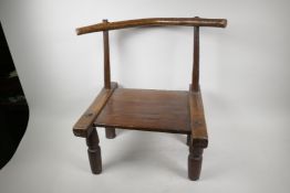 An Indian hardwood low chair of rustic design with single rail back and carved legs, seat 9" high