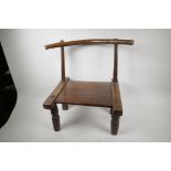 An Indian hardwood low chair of rustic design with single rail back and carved legs, seat 9" high