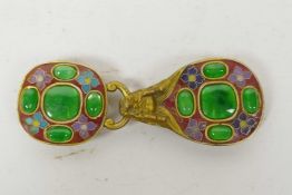 A gilt and cloisonne belt buckle in the form of a dragon set with green stones, 4" long