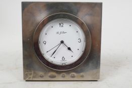 A silver cased bedroom clock by R.J. Carr, the case 4" square with round dial and black hands and