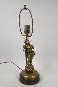 An early C20th French bronze table lamp in the form of a putti carrying a wheatsheaf, 18" high