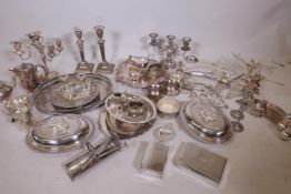 A good quantity of silver plated ware, including a pair of tureens, two pairs of candlesticks, two