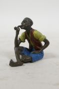 A cold painted bronze in the manner of Bergman, of a man smoking a pipe, 2½" high