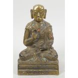 A small bronze figure of Buddha seated in meditation with engraved decoration, studded with