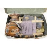 A box of vintage fishing accessories including two hardwood and brass reels, hooks, floats etc