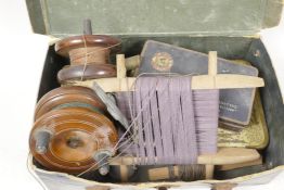 A box of vintage fishing accessories including two hardwood and brass reels, hooks, floats etc