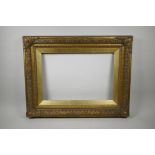 A C19th gilt composition picture frame, with flower and scroll decoration, rebate 13" x 19"