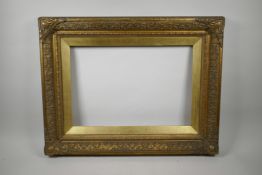 A C19th gilt composition picture frame, with flower and scroll decoration, rebate 13" x 19"
