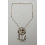 A Chinese white metal pendant necklace with pierced bat and dragon decoration, 24" long