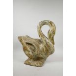 An Indian carved, painted and distressed wooden swan, the wings inset with multicoloured mirrored