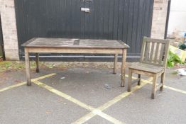 A teak garden table and chair by P.J. Bridgman & Co, 72" x 35½", 29" high