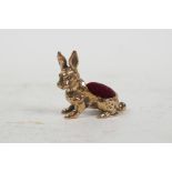 A novelty brass pincushion in the form of a rabbit, 1"