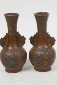 A pair of Japanese patinated antimony bottle vases with applied floral decoration, 3½" high