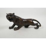 An Oriental filled bronze of a tiger, 12" long