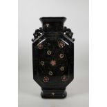 An Oriental black ground porcelain vase with two pierced handles, with chased and enamelled floral