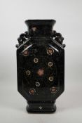 An Oriental black ground porcelain vase with two pierced handles, with chased and enamelled floral
