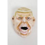A painted cast metal Donald Trump bottle opener, 4" x 3½"