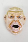 A painted cast metal Donald Trump bottle opener, 4" x 3½"