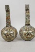 A pair of Japanese Satsuma bottle vases with applied silver wire banding, and painted with birds and