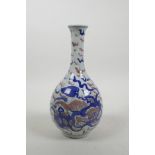A Chinese blue and white porcelain bottle vase decorated with fo dogs and highlighted with red,