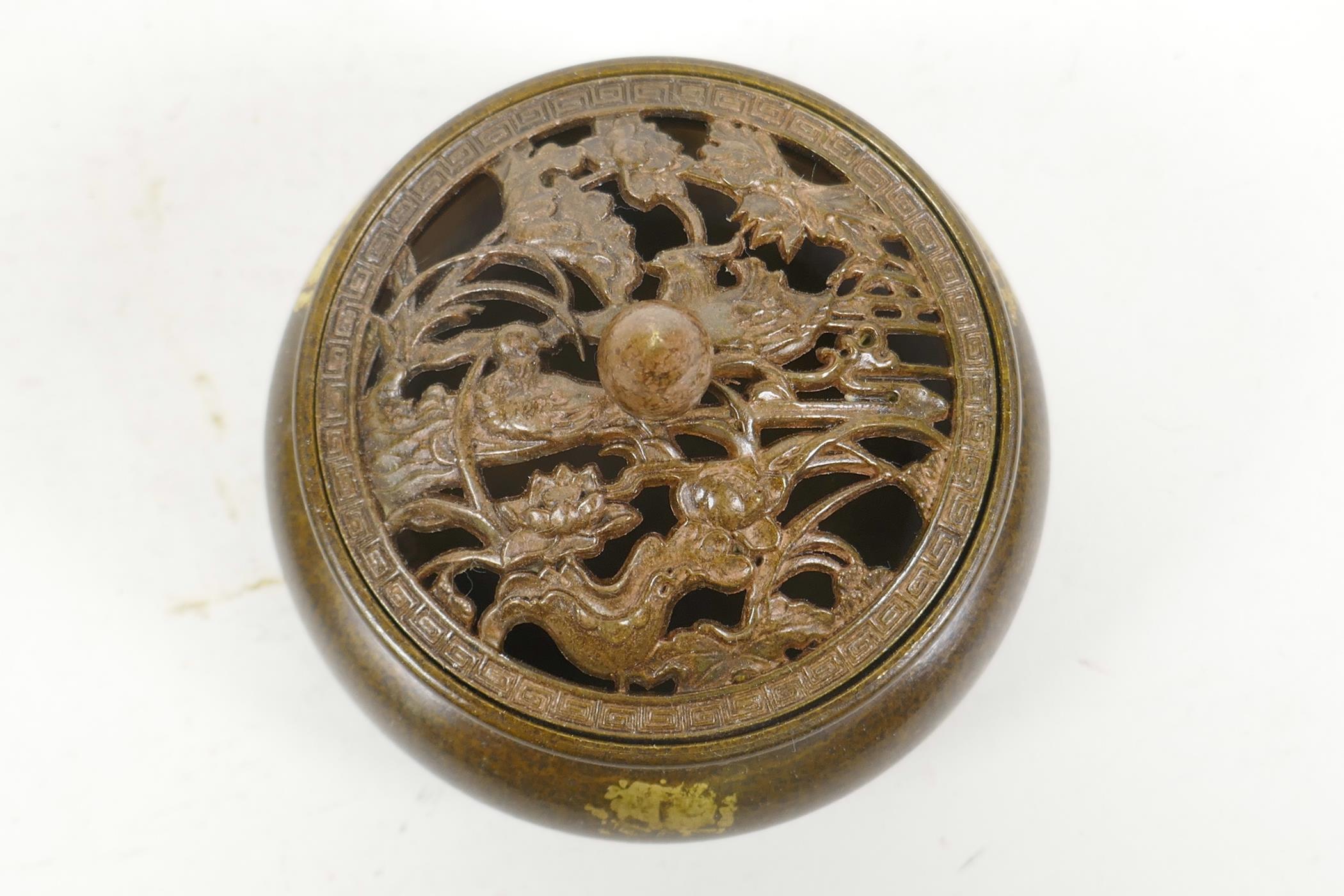A Chinese gilt splash bronze censer and cover on tripod feet, with pierced waterfowl and lotus - Image 2 of 3