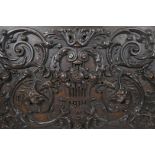 A fine C18th panel, possibly Flemish oak carving of scrolling foliate design, incorporating a lyre