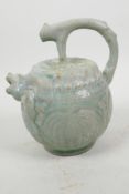 A Chinese green celadon glazed pourer with spout in the form of a mythical beast, 7" high