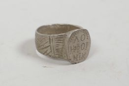 A Byzantine style white metal ring with an engraved oval cartouche