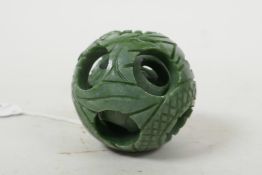 A Chinese carved hardstone puzzle ball, 2" diameter