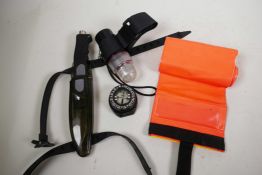 A scuba diver's knife in scabbard, 11" long, together with a compass, torch and fluorescent