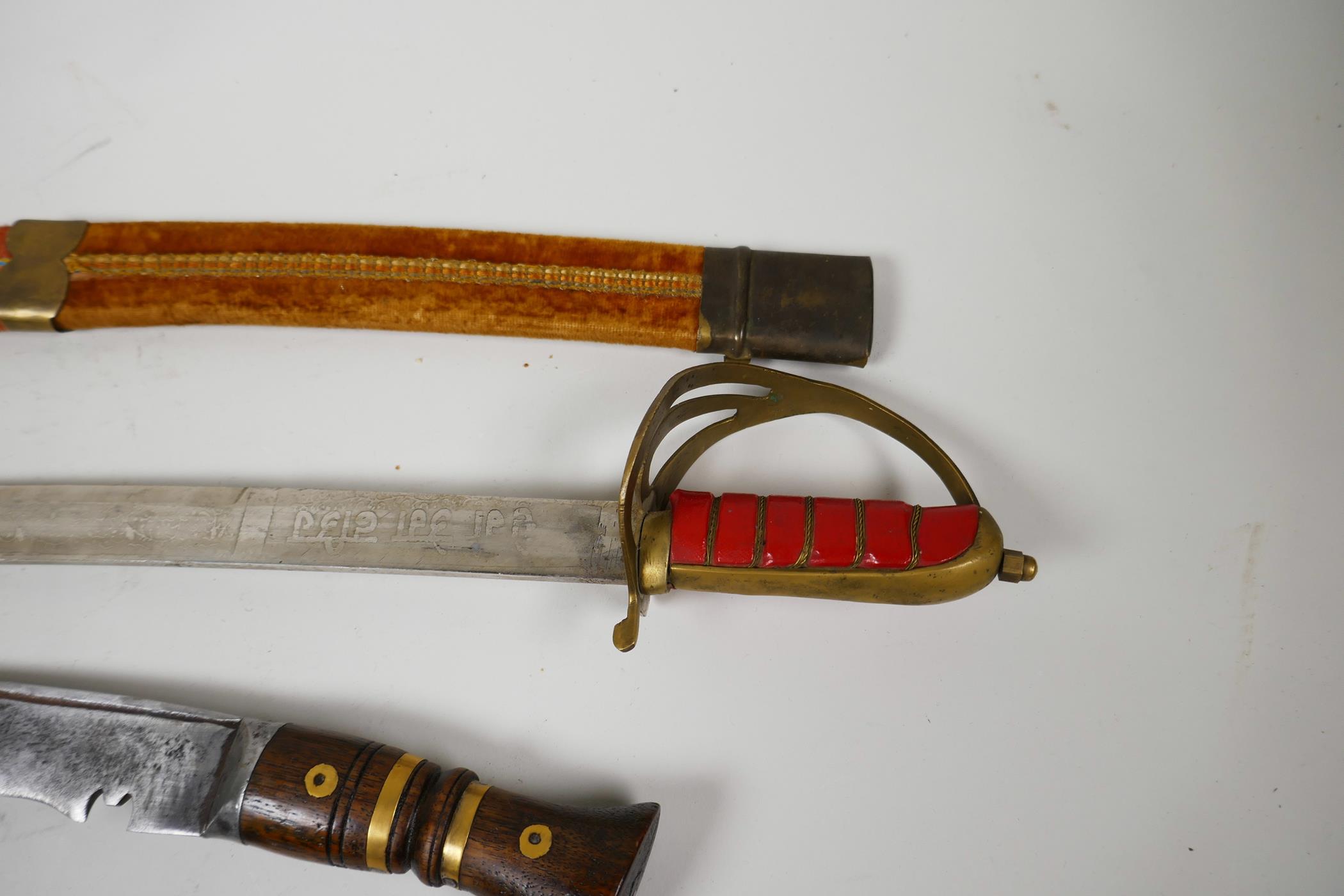 An Oriental Indian sword in velvet covered scabbard, 27½" long together with a wood and brass - Image 5 of 5