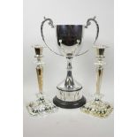 A pair of classical style silver plated candlesticks, 11" high, together with a silver plated trophy