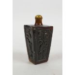 A Chinese horn snuff bottle with carved kylin decoration, 3½" high