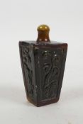 A Chinese horn snuff bottle with carved kylin decoration, 3½" high