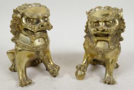 A pair of Chinese gilt metal figures of temple lions, 5¼" high