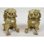 A pair of Chinese gilt metal figures of temple lions, 5¼" high