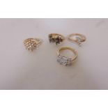 Four gilt cocktail rings set with cubic zirconia stones