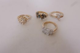 Four gilt cocktail rings set with cubic zirconia stones
