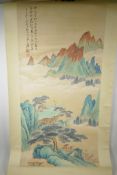 A Chinese watercolour scroll depicting a solitary figure in a mountain landscape, 19½" x 39"