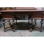 A Continental mahogany four drawer kneehole desk, raised on turned supports with shaped