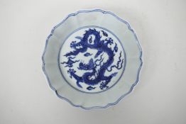 A Chinese blue and white porcelain dish of lobed form decorated with dragons in flight, 6