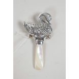 A sterling silver baby's rattle in the form of a swan with a mother of pearl handle, 3" long