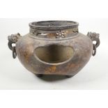 A large bronzed metal censer with two mask ring handles, pierced sides and gilt patination, 7" high,